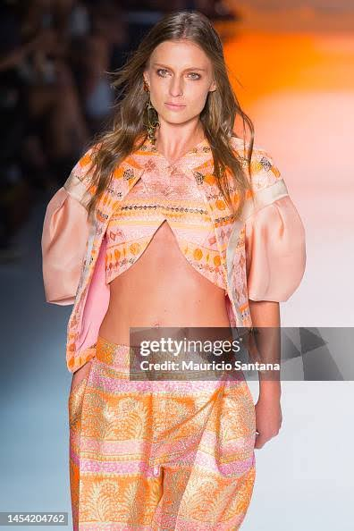 Brazilian model Fernanda Liz walking a fashion week runway.